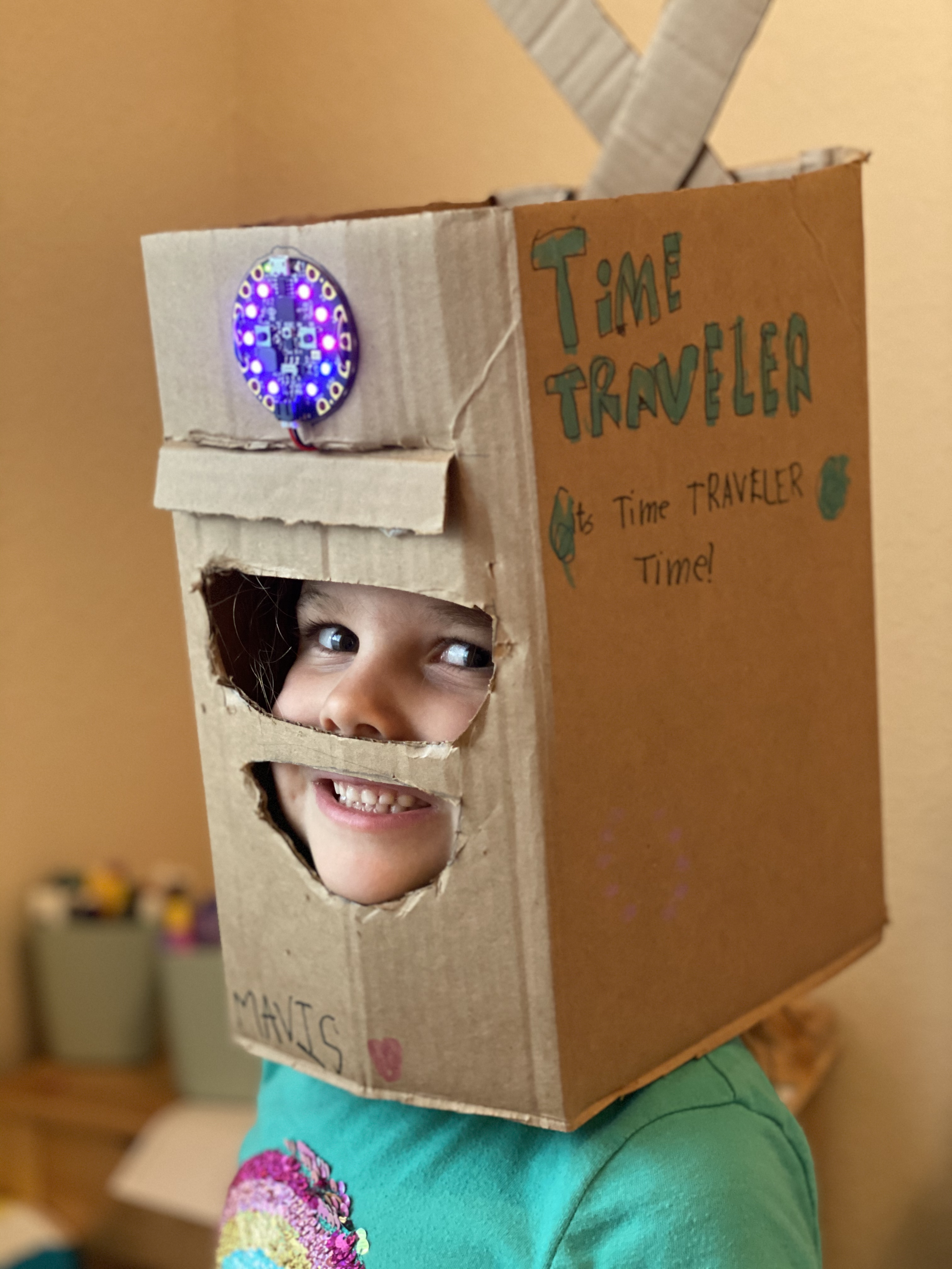 a happy child wearing the time travel helmet described above